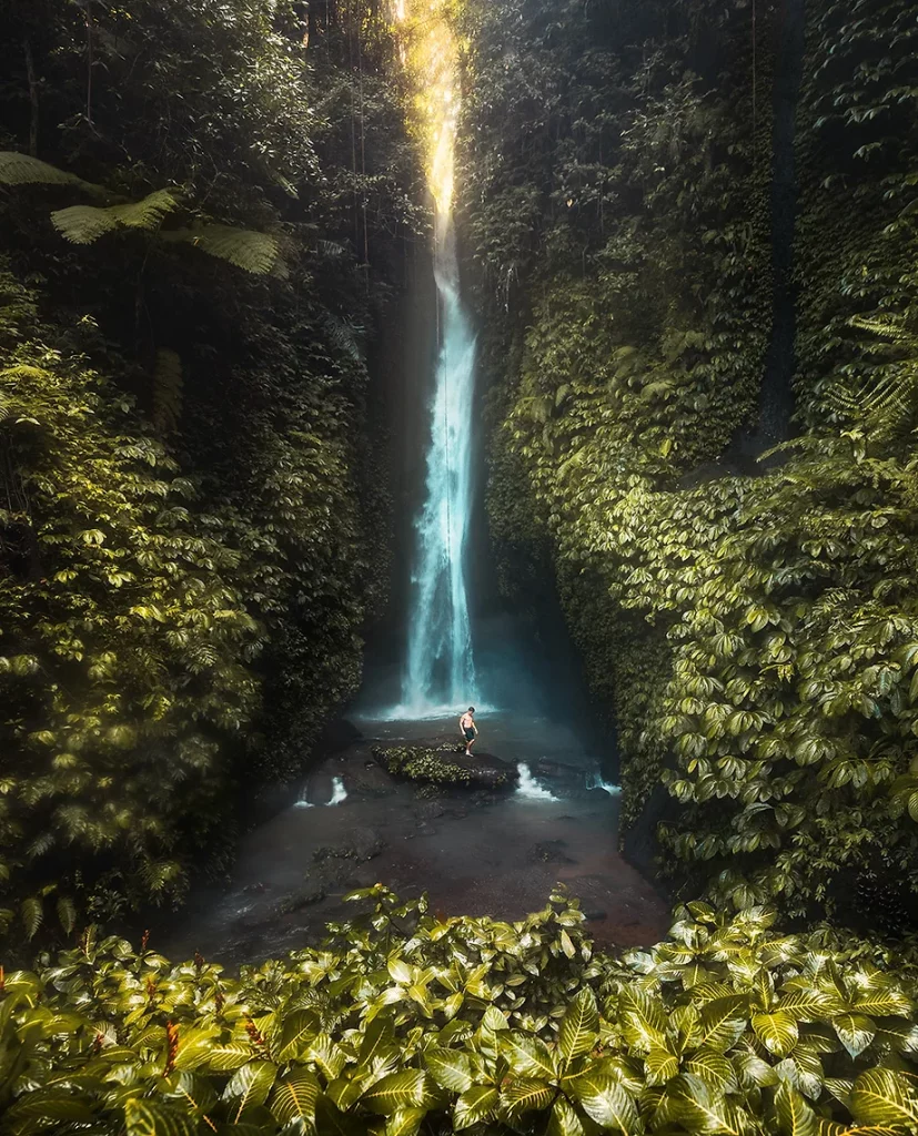 The secluded Leke Leke Waterfall surrounded by lush greenery in Bali.