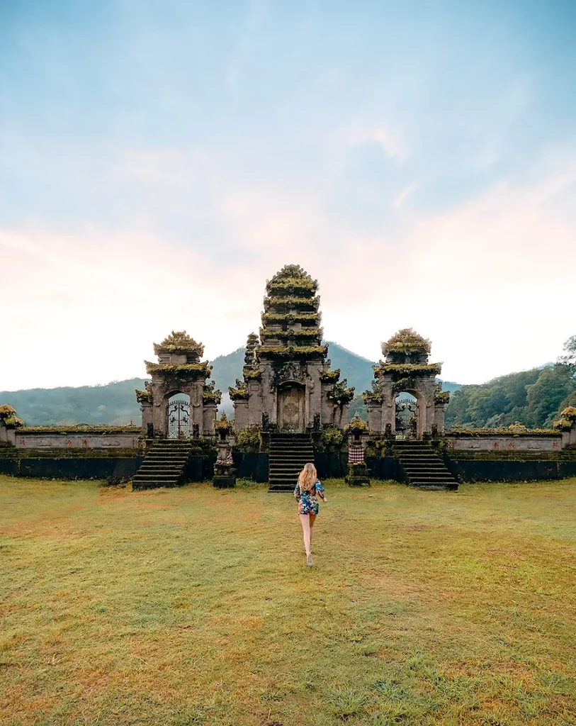 Pura Ulun Danu Bratan Temple at sunrise, surrounded by water, one of the top places to visit in Bali.