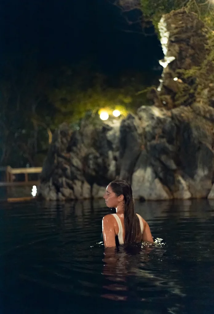 People relaxing in the natural thermal waters of Maquinit Hot Springs in Coron.