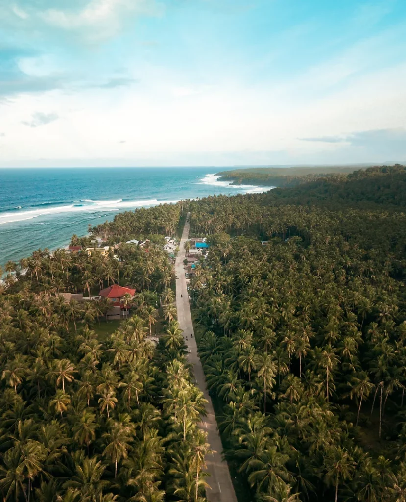 Surfers catching waves on Siargao Island, Philippines.