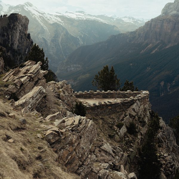 A 4X4 vehicle driving through the rugged trails of Ordesa National Park surrounded by lush greenery and towering peaks. 7-day itinerary exploring Huesca’s adventure destinations