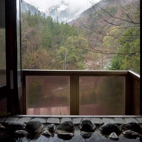 A beautifully designed onsen bathhouse with steaming hot water.