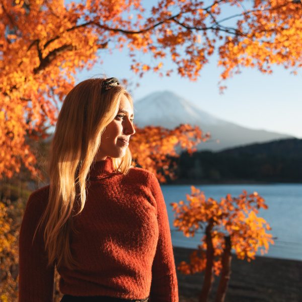 Vibrant autumn leaves at Momiji Tunnel with Mount Fuji in the background, showcasing autumn in Japan.