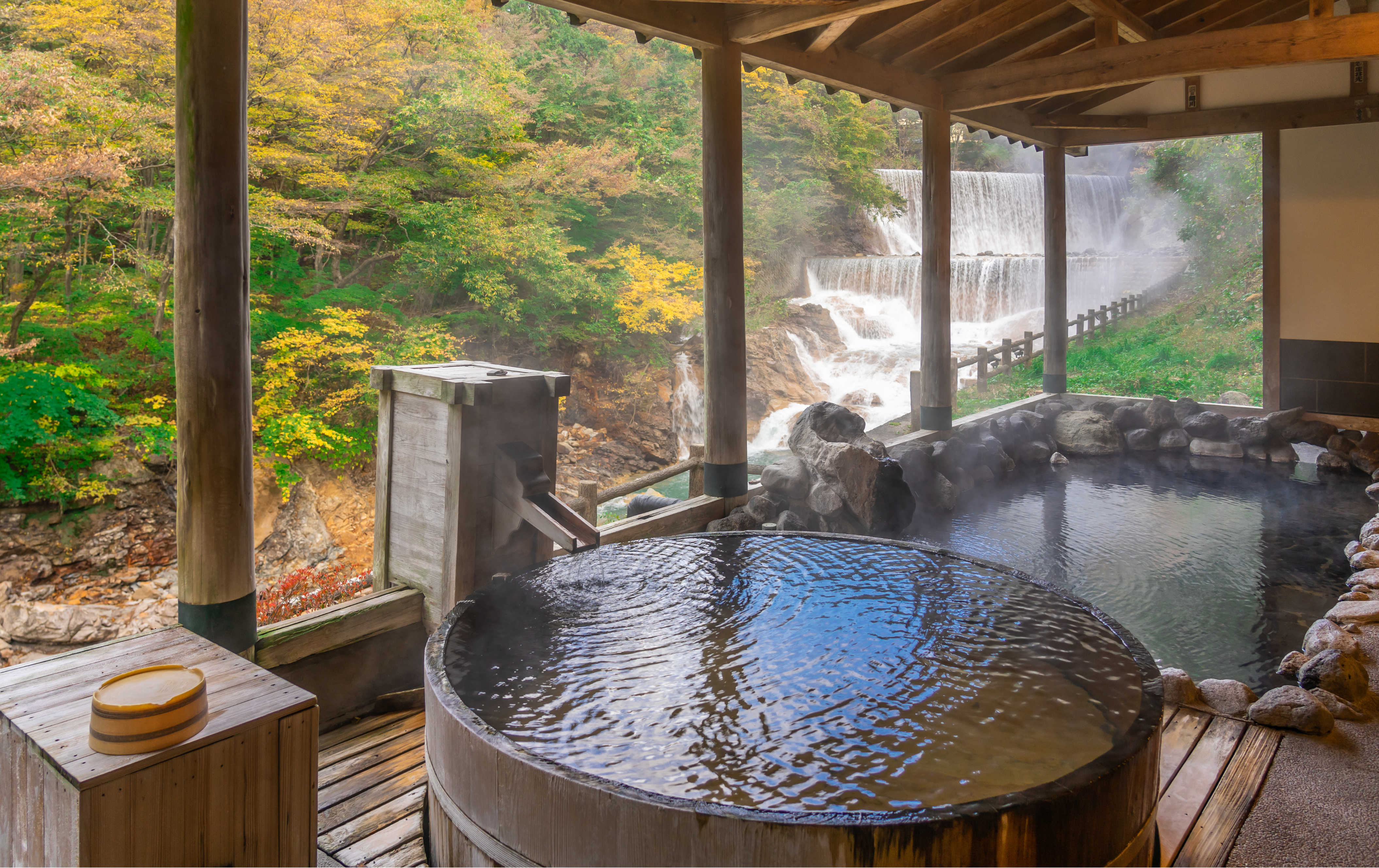Experience the serene ambiance of a traditional Japanese onsen surrounded by nature.