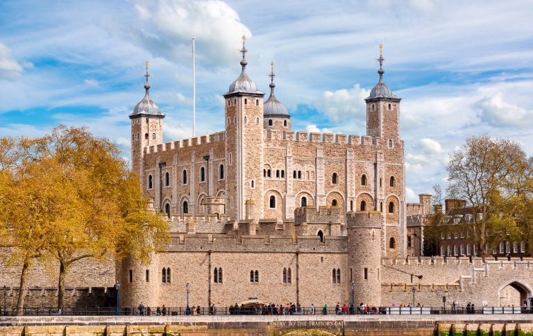 The historic Tower of London with the River Thames in the foreground.