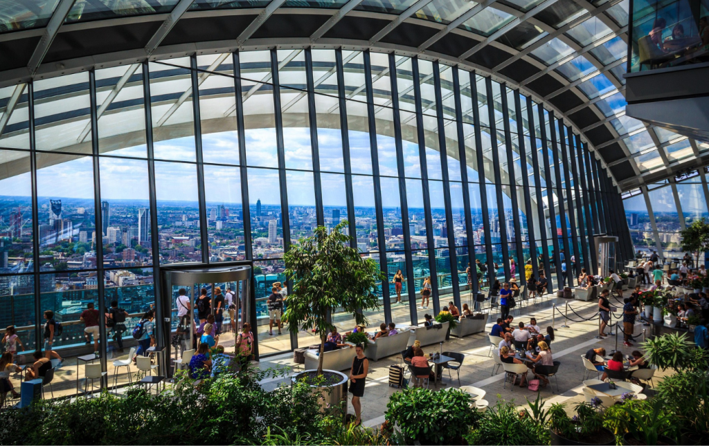 Inside the Sky Garden, featuring exotic plants and lush greenery against a modern glass structure.