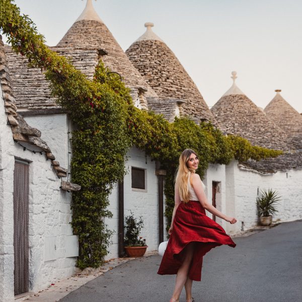 Traditional Trulli houses in Alberobello with flowers and cobbled paths