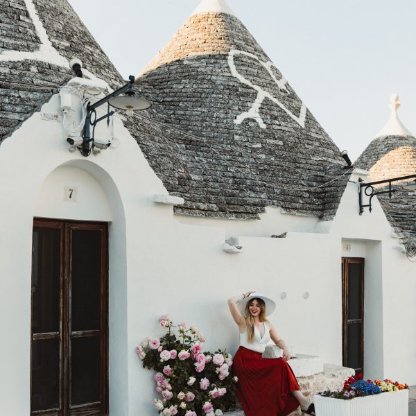 Traditional Trulli houses in Alberobello with flowers and cobbled paths
