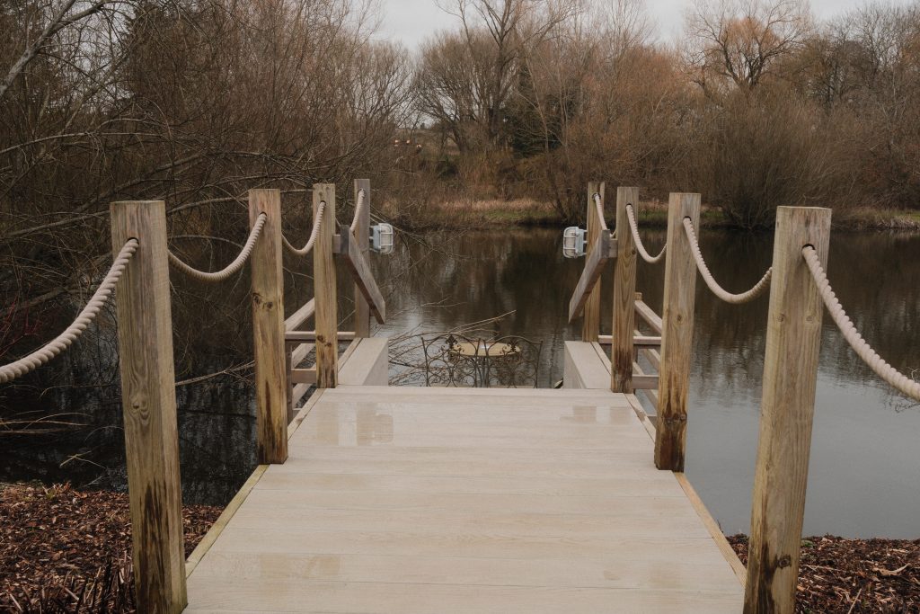 Deck by the river outside the Tewinbury Lake Huts