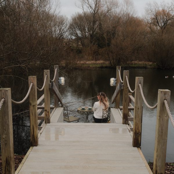 Deck by the river outside the Tewinbury Lake Huts