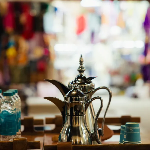 Traditional brass dallah coffee pot on display in a Sharjah souk