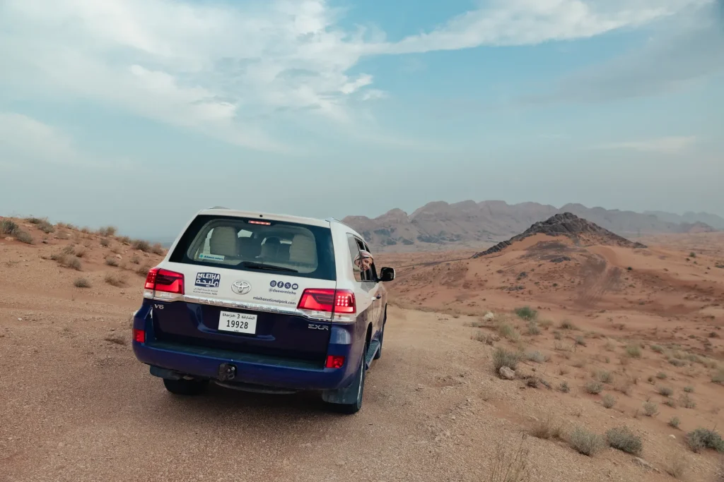 4x4 driving along a desert track towards the mountains in Mleiha, Sharjah