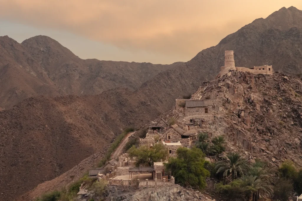 Najd Al Meqsar stone village and watchtower in the Hajar Mountains near Khorfakkan at sunset