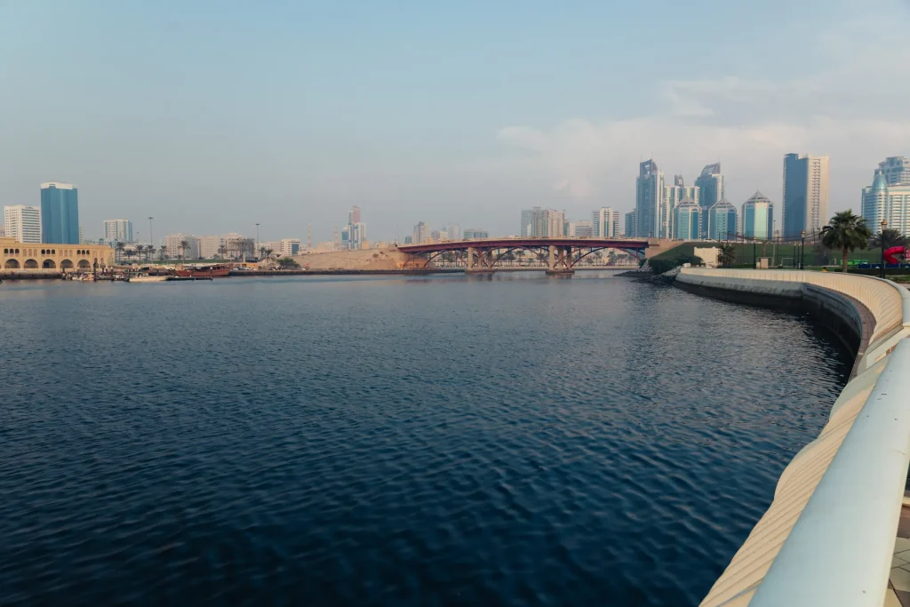 Sharjah skyline seen across the calm water of the waterfront