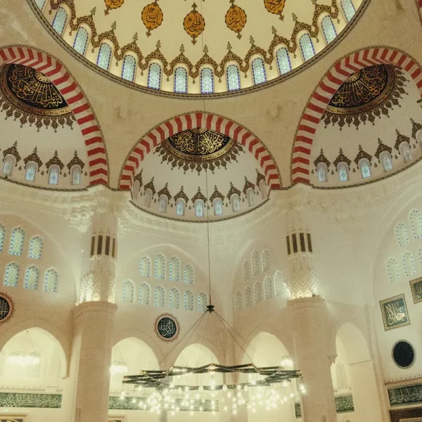 Painted dome and chandeliers inside the main prayer hall of Sharjah Mosque