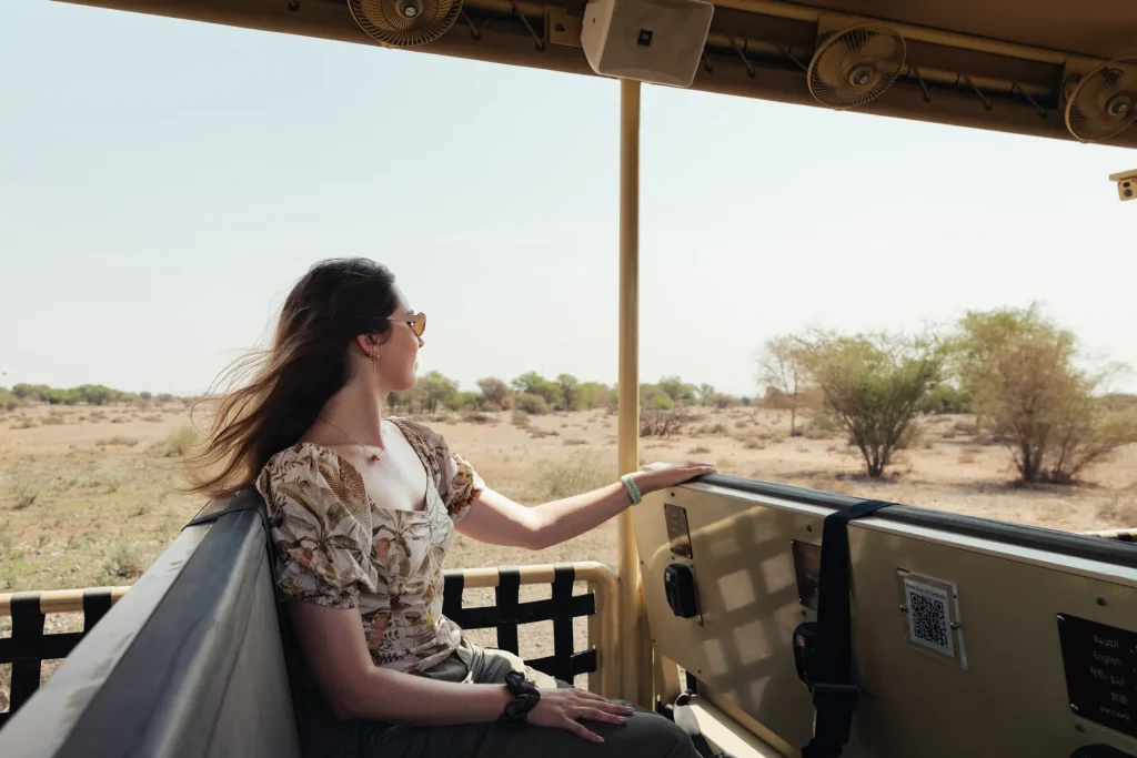 Helena riding in an open safari vehicle across the savannah at Sharjah Safari