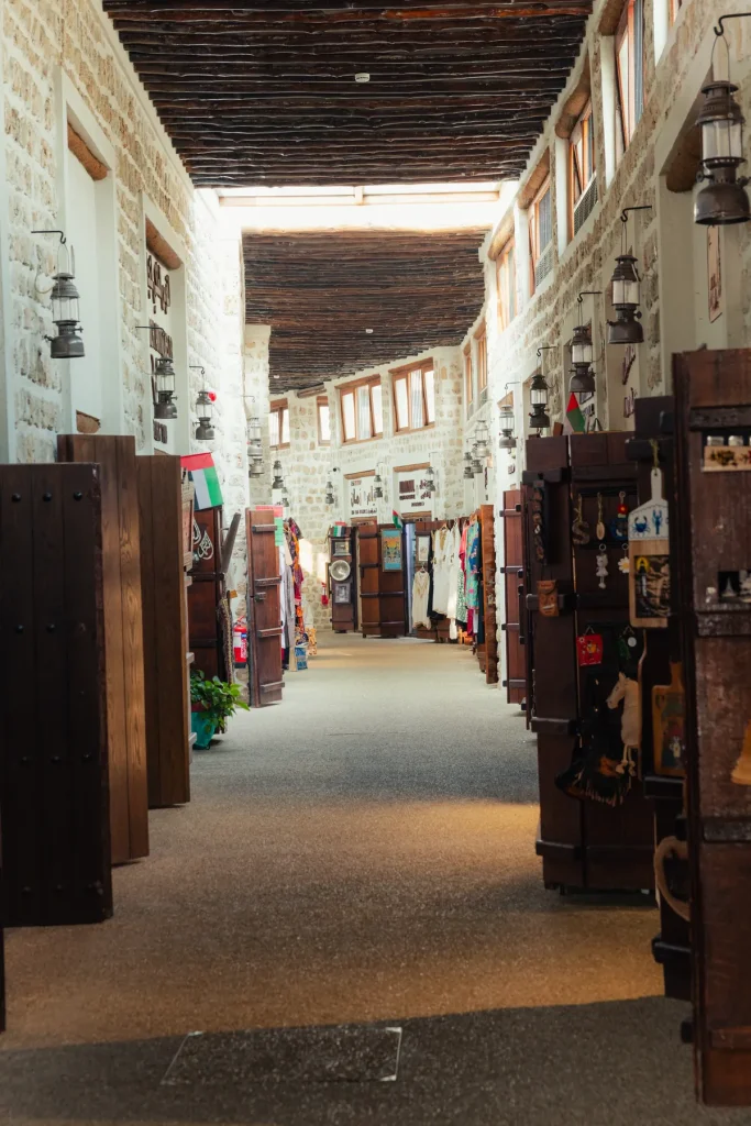 Covered wooden-beamed walkway lined with shops in Souk Al Arsah, Sharjah