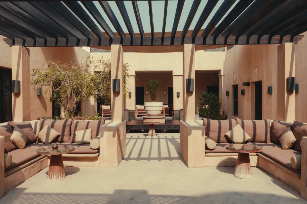 Shaded courtyard with majlis seating at The Chedi Al Bait hotel, Sharjah
